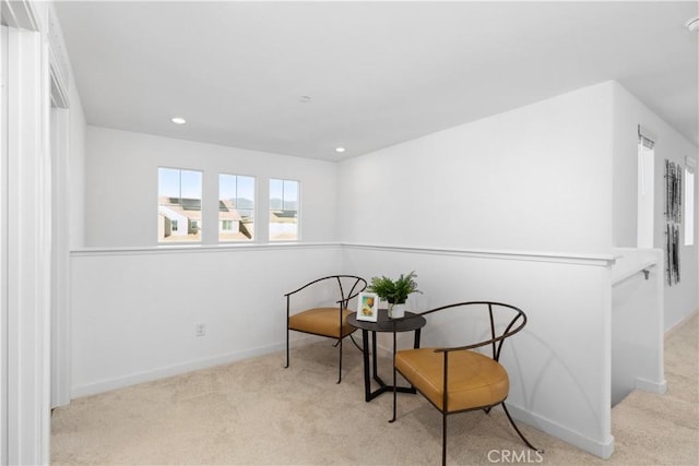 sitting room featuring light colored carpet