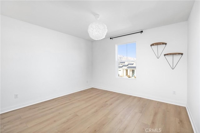 spare room with light hardwood / wood-style floors