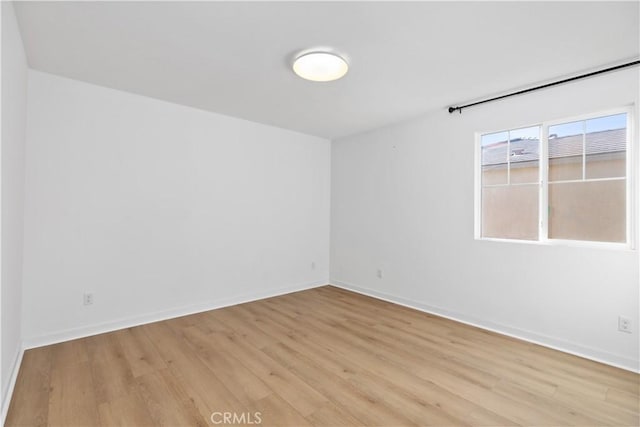 empty room with light hardwood / wood-style flooring