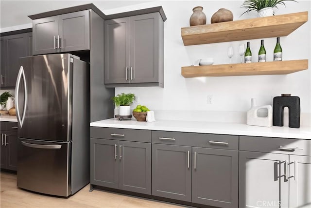 kitchen featuring stainless steel fridge and gray cabinets