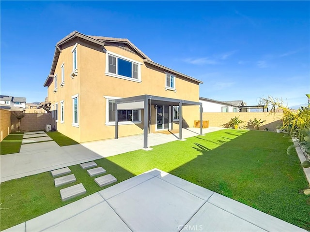 rear view of house with a patio area and a yard