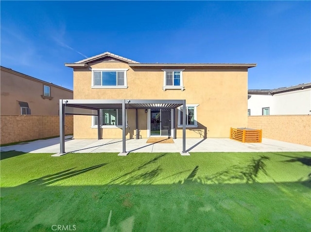 back of property with a lawn, a pergola, and a patio