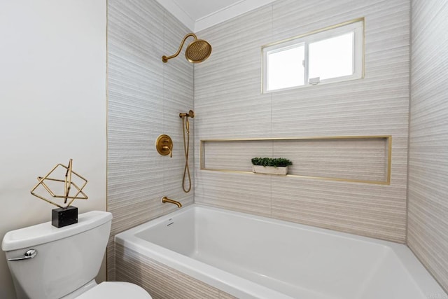 bathroom featuring tiled shower / bath and toilet