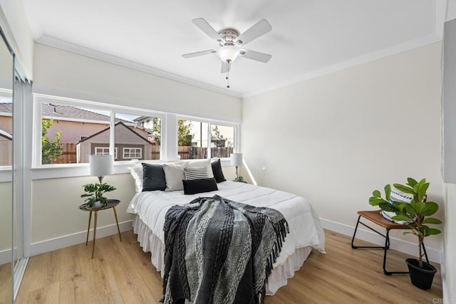 bedroom featuring crown molding, ceiling fan, and light hardwood / wood-style floors