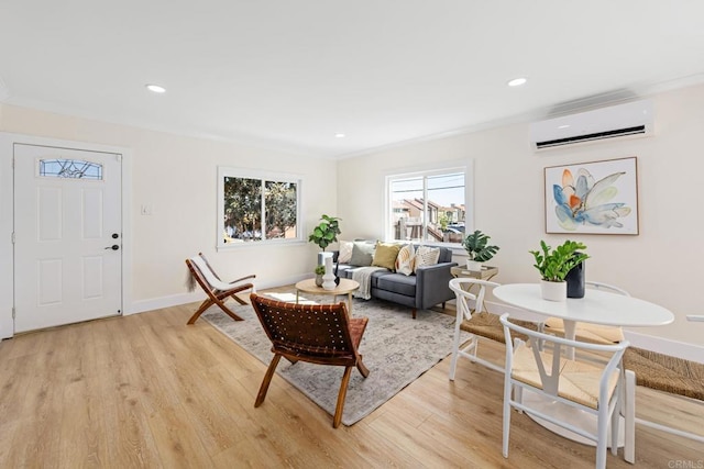 living room featuring a wall mounted AC and light hardwood / wood-style floors