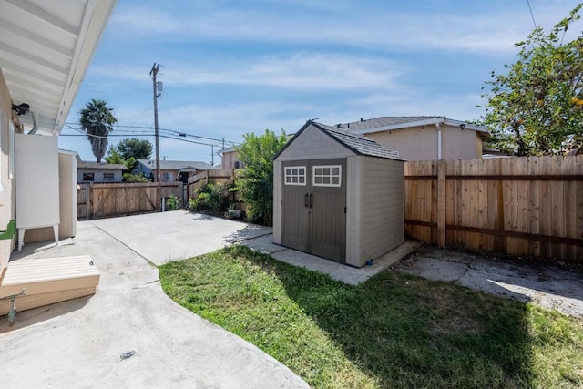 view of yard with a patio and a shed