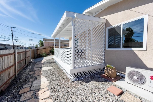 view of side of home featuring ac unit