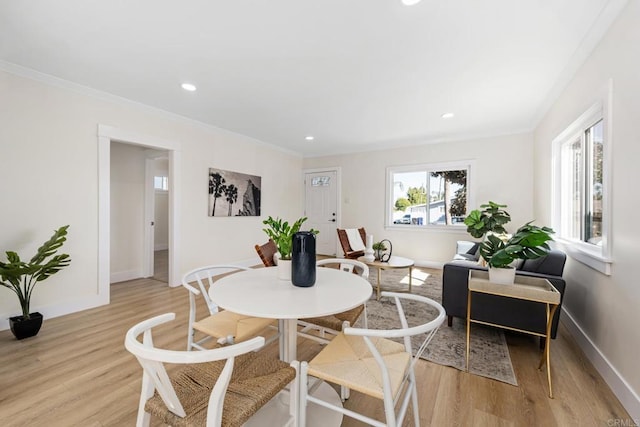 dining room featuring ornamental molding and light hardwood / wood-style floors