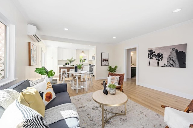 living room featuring crown molding, a wall mounted AC, and light wood-type flooring