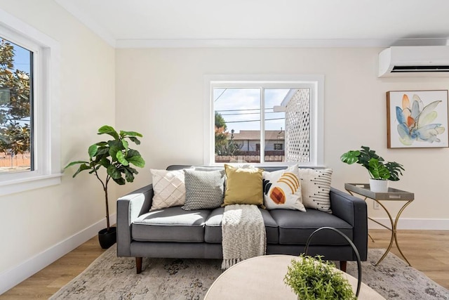 living room featuring a healthy amount of sunlight, a wall mounted AC, and light wood-type flooring