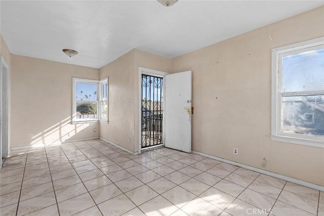 unfurnished room with light tile patterned floors