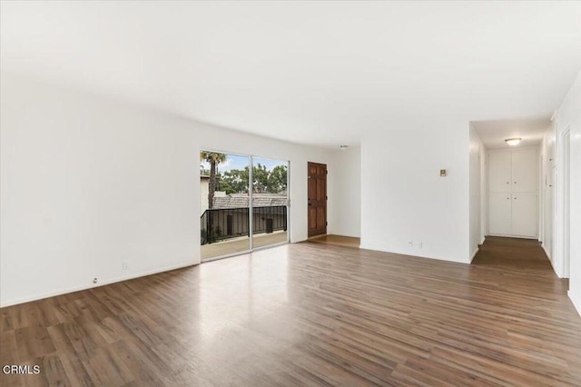 empty room featuring dark wood-type flooring