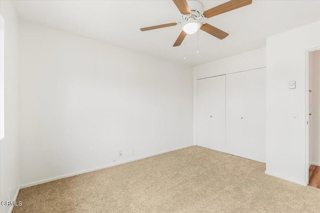 unfurnished bedroom featuring ceiling fan, a closet, and light carpet