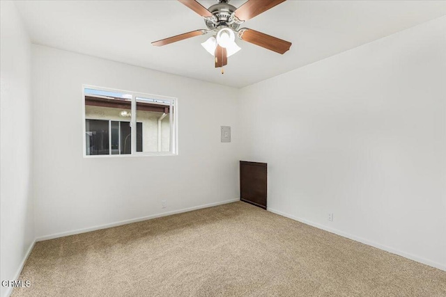 carpeted spare room with ceiling fan