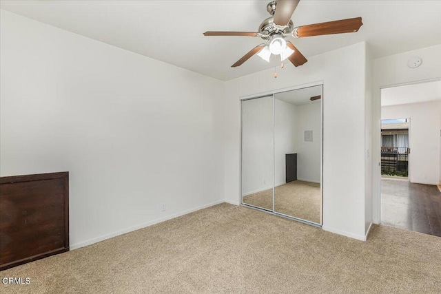 unfurnished bedroom featuring ceiling fan, carpet, and a closet