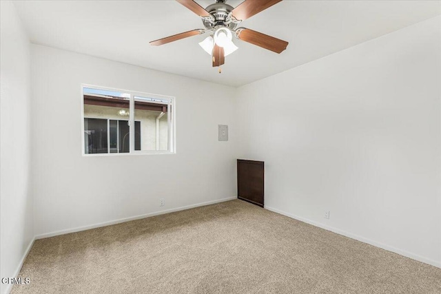 unfurnished room with ceiling fan and carpet