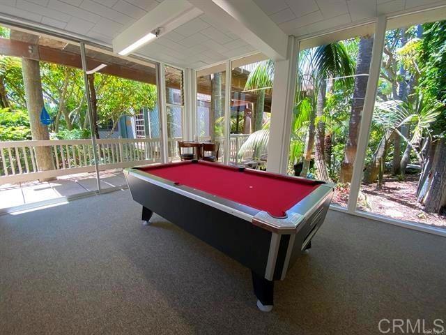 recreation room featuring carpet, beam ceiling, plenty of natural light, and pool table