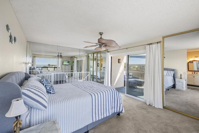 carpeted bedroom featuring ceiling fan, connected bathroom, access to exterior, and a textured ceiling