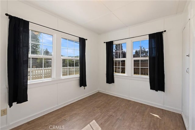 spare room with hardwood / wood-style flooring