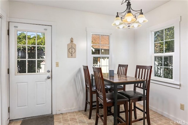 dining room featuring plenty of natural light and a notable chandelier