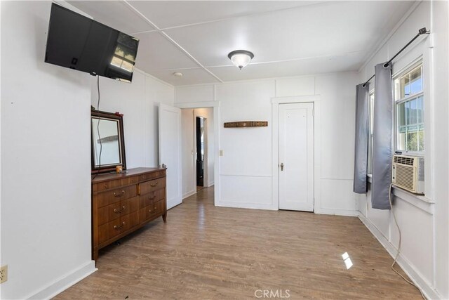 bedroom featuring cooling unit and light hardwood / wood-style floors