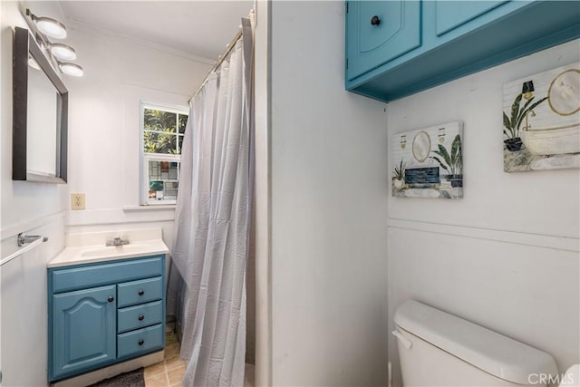 bathroom featuring toilet, crown molding, and vanity