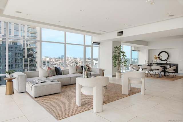 tiled living room with expansive windows and a healthy amount of sunlight