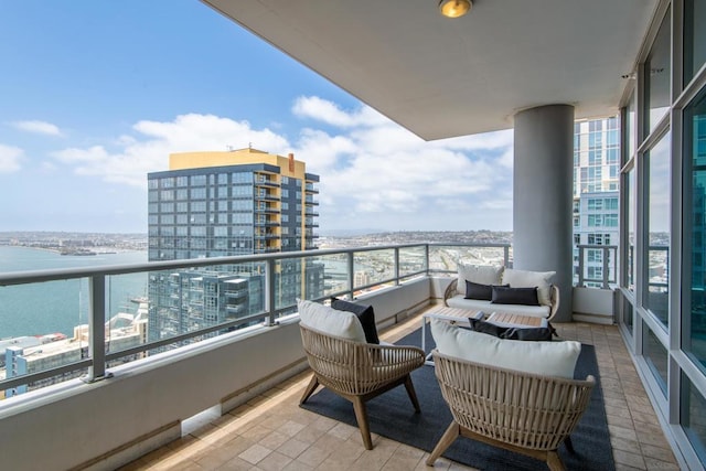 balcony with a water view and outdoor lounge area