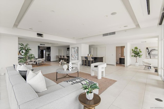 tiled living room with a raised ceiling