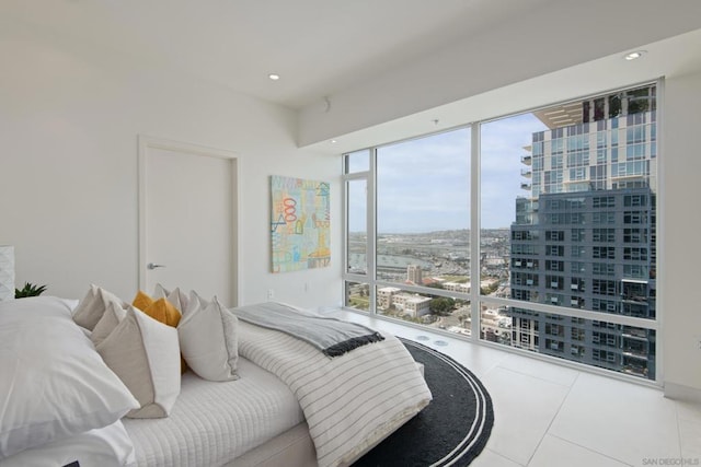 bedroom featuring tile patterned floors and a wall of windows