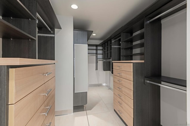 spacious closet featuring light tile patterned flooring