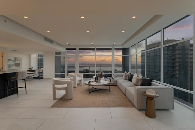 tiled living room featuring expansive windows