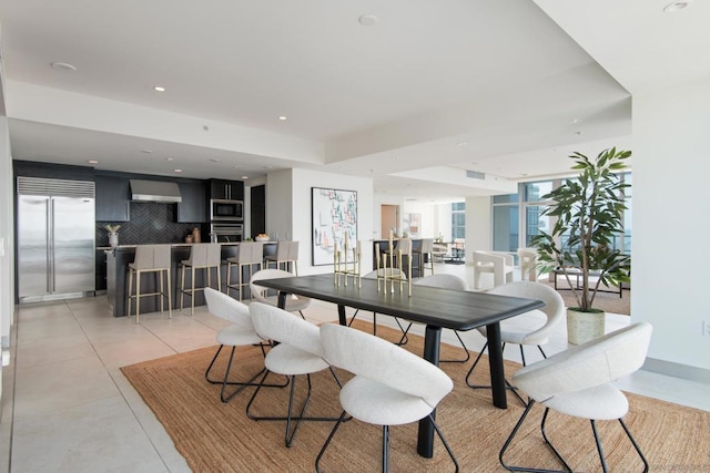 dining room with light tile patterned floors and floor to ceiling windows