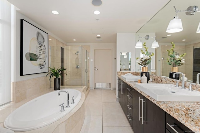 bathroom with tile patterned floors, separate shower and tub, and vanity