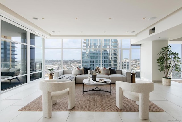 living room with floor to ceiling windows and light tile patterned floors