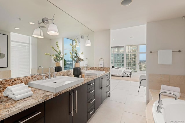 bathroom with floor to ceiling windows, tile patterned floors, vanity, and a bath