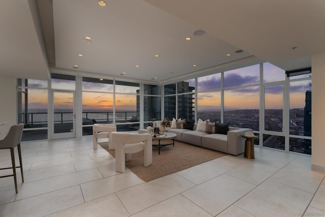 tiled living room featuring expansive windows