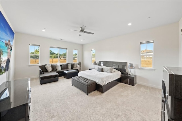 bedroom featuring light carpet and ceiling fan