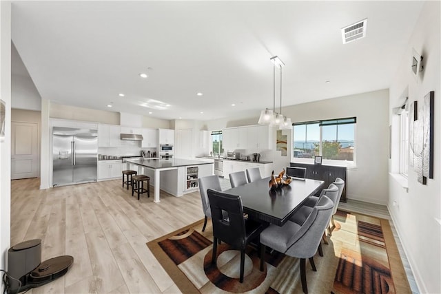 dining space featuring light wood-type flooring