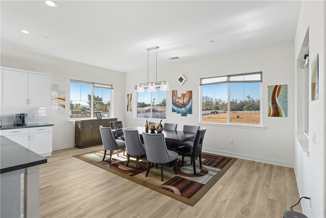 dining space with light hardwood / wood-style flooring