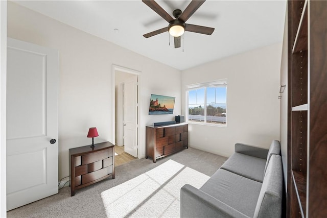 living room featuring ceiling fan and light colored carpet