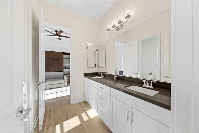 bathroom with ceiling fan, vanity, and hardwood / wood-style floors