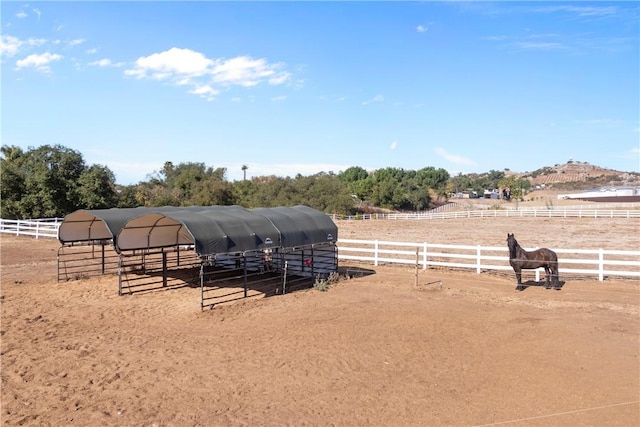 view of yard featuring an outbuilding and a rural view