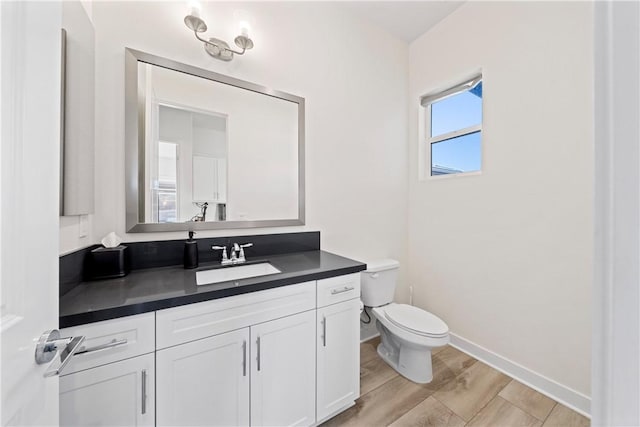 bathroom featuring toilet and vanity