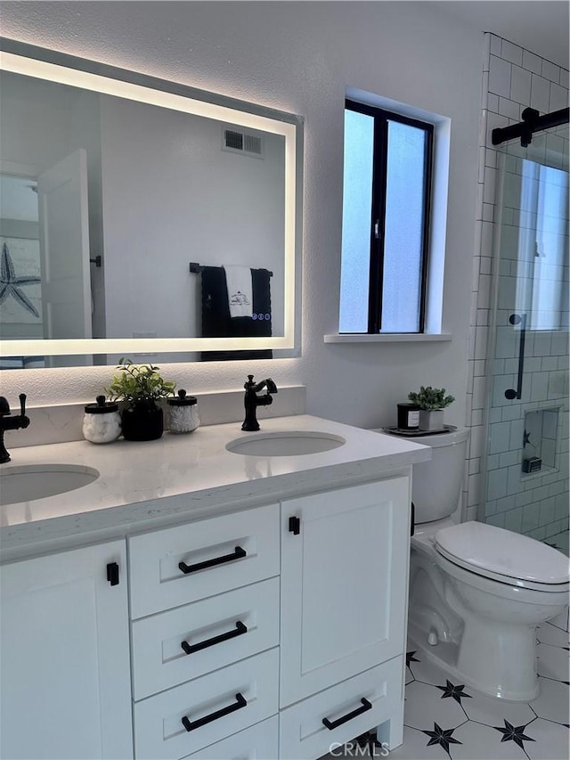 bathroom with toilet, tile patterned flooring, walk in shower, and vanity