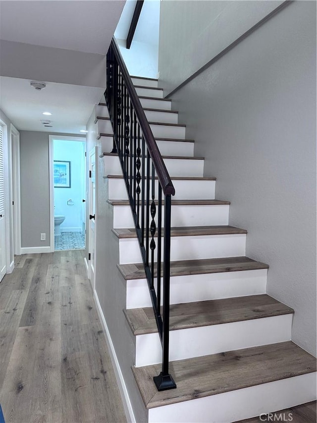 stairway featuring hardwood / wood-style flooring