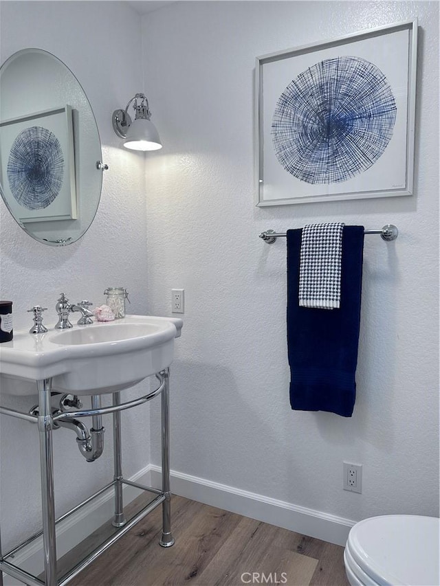 bathroom featuring toilet and hardwood / wood-style floors