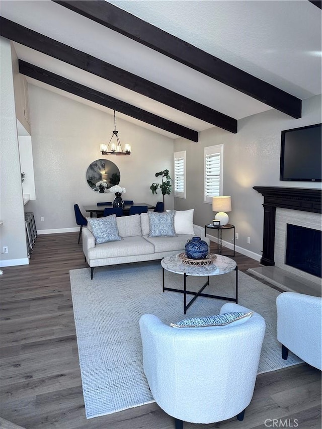 living room featuring dark hardwood / wood-style flooring, lofted ceiling with beams, and an inviting chandelier