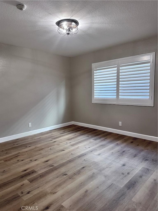 unfurnished room featuring hardwood / wood-style flooring