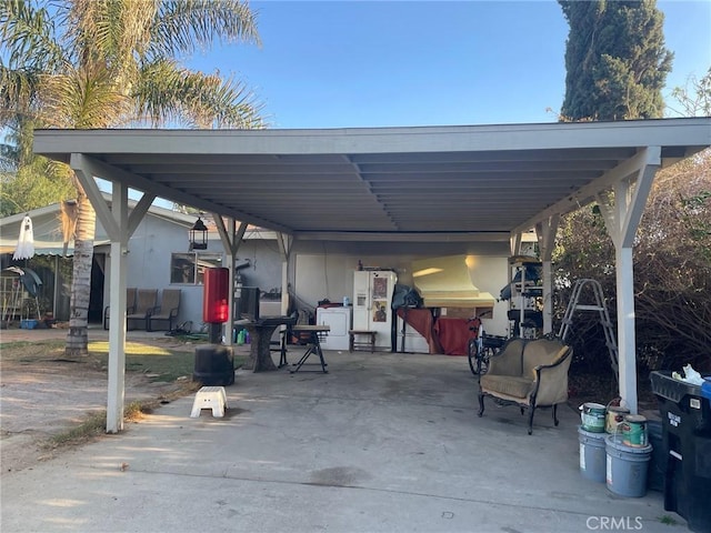 view of vehicle parking featuring a carport and washer / dryer